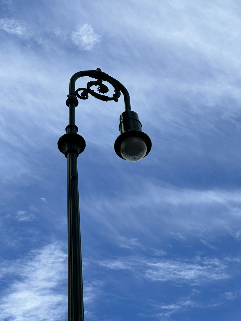 a street light with a blue sky in the background