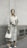 A stylish woman wearing a classic trench coat in an urban setting.