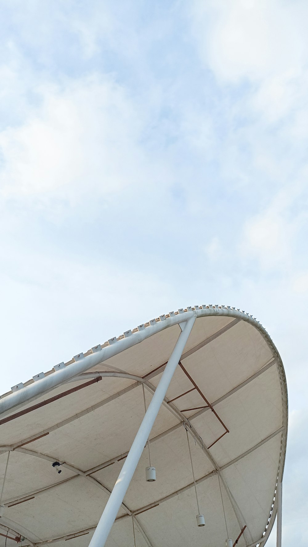 a large metal structure with a sky in the background