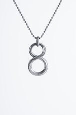 a silver necklace with two intertwined circles