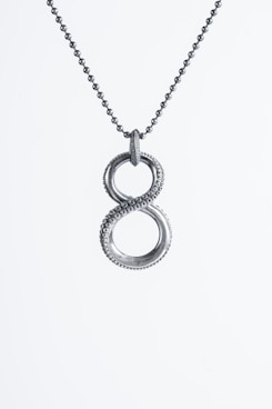 a silver necklace with two intertwined circles