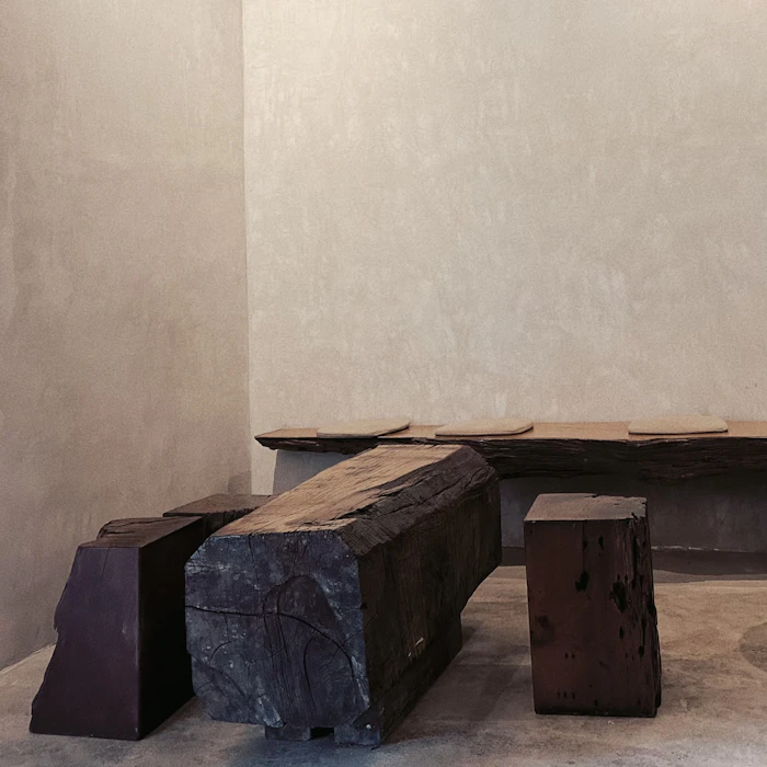 Reclaimed timber bench against a plaster wall