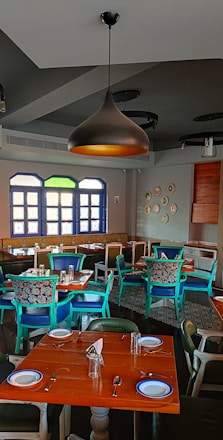 A warm, inviting traditional Turkish restaurant interior with wooden tables and colorful dishes served.
