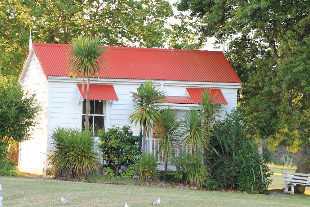 a small white house with a red roof