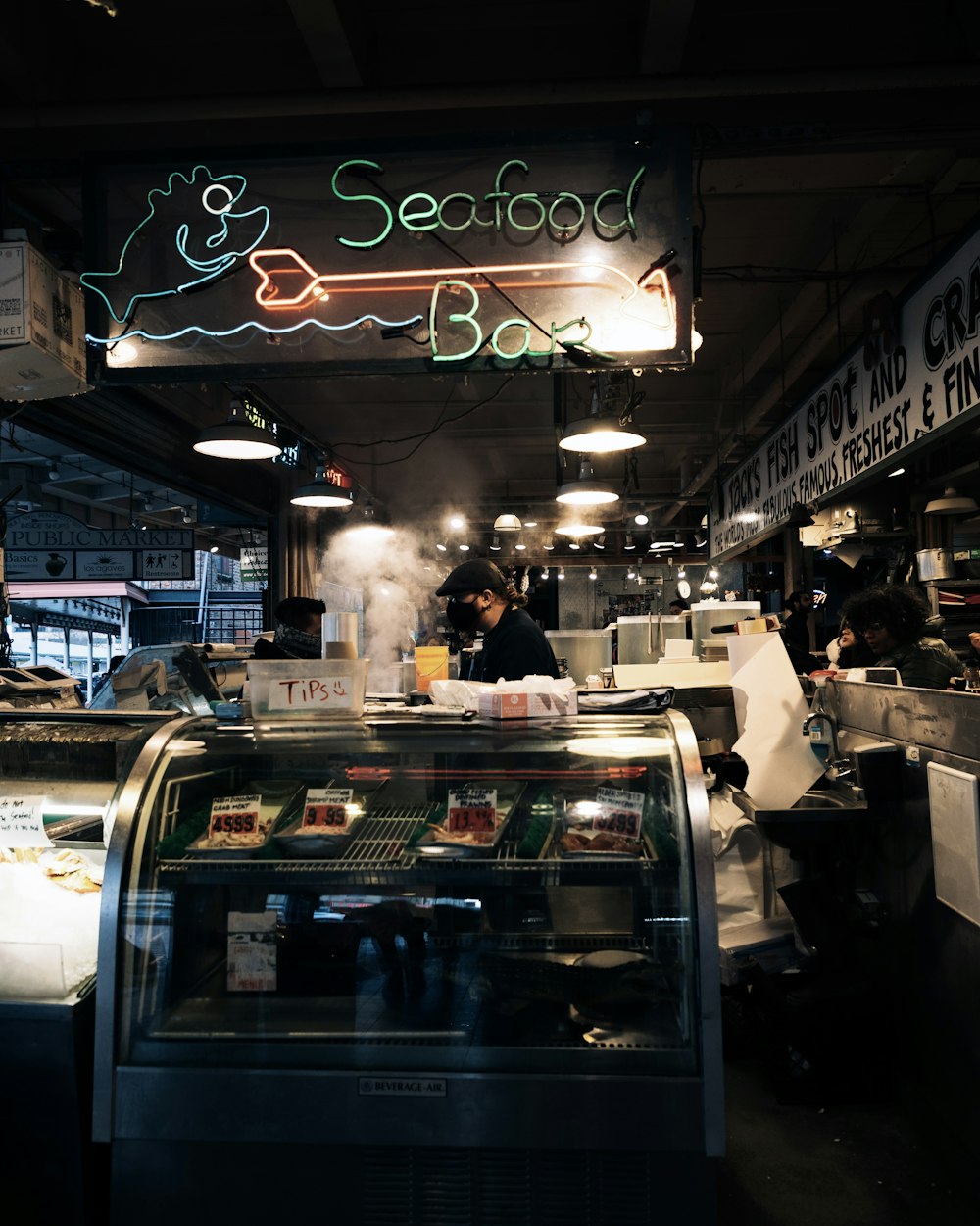 a food stand with a neon sign above it