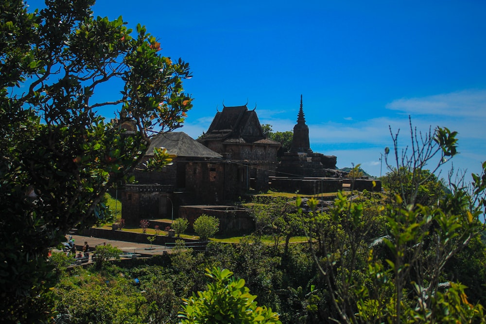 a large building sitting on top of a lush green hillside