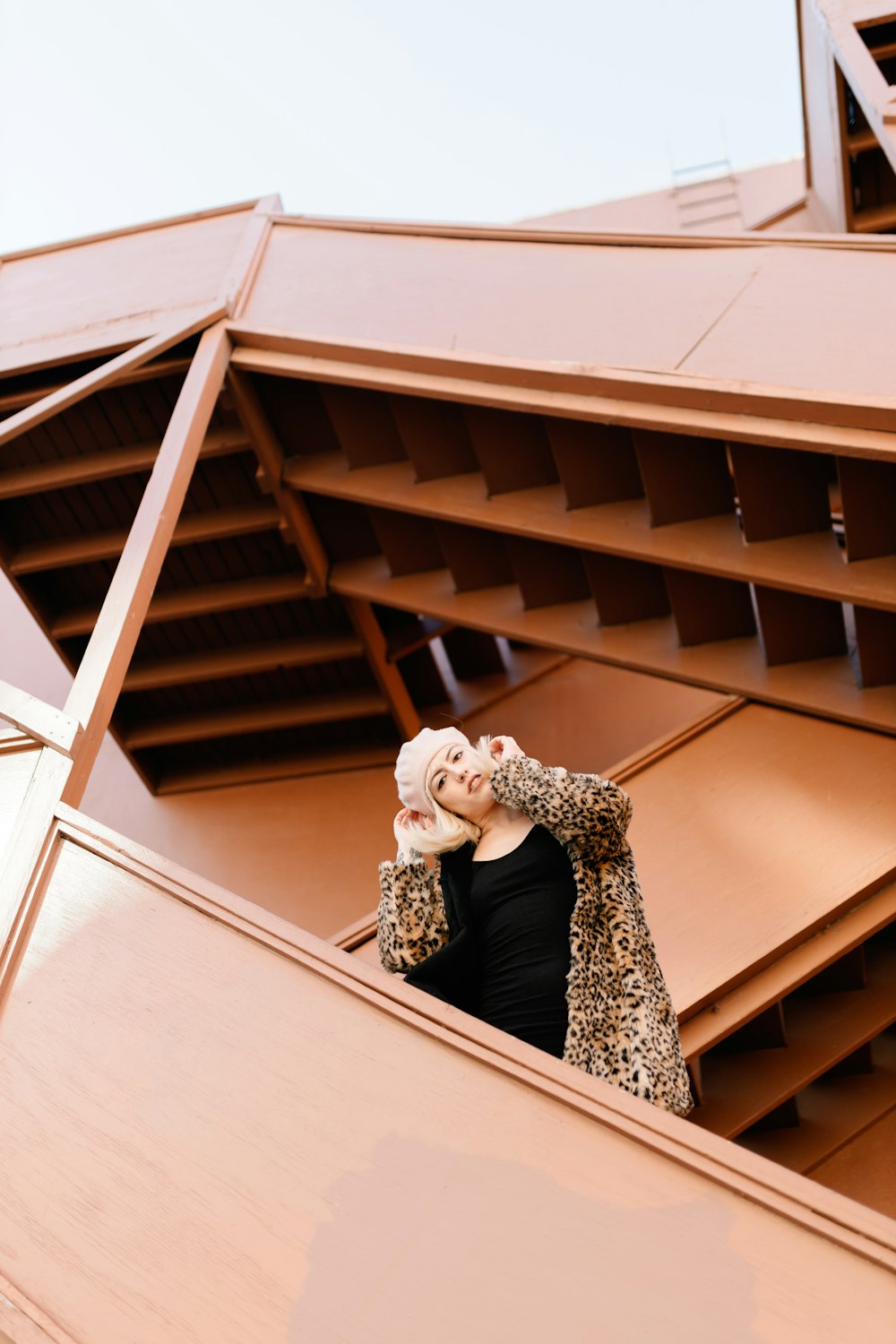 a woman standing on top of a building talking on a cell phone