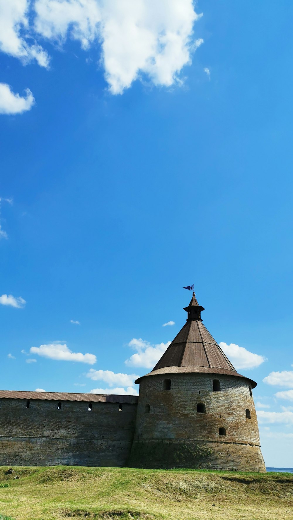 a tall tower with a cross on top of it