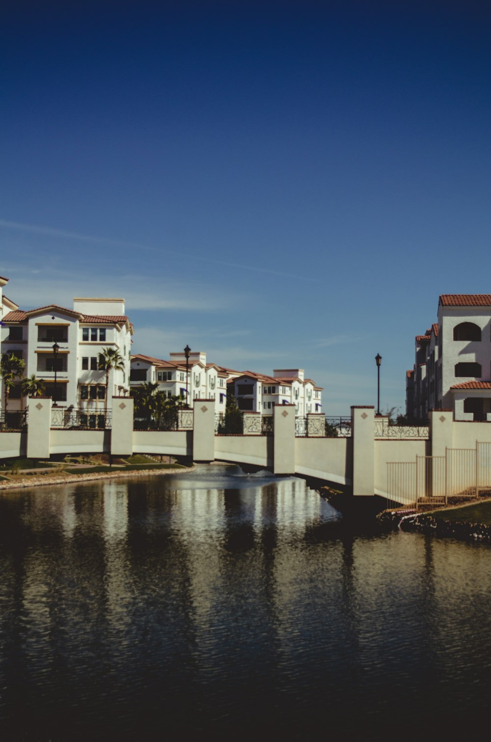 a bridge over a body of water with buildings in the background