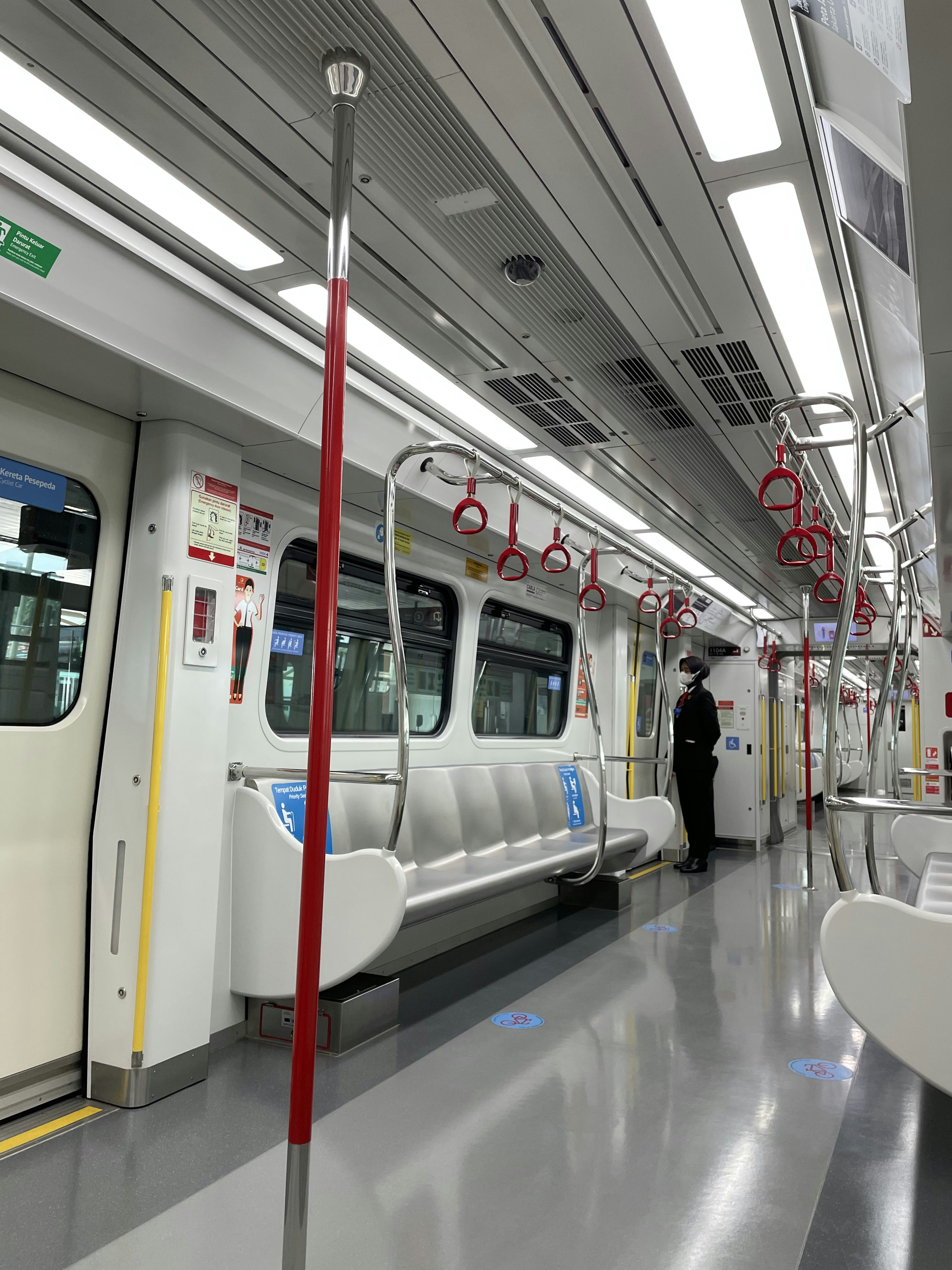 a subway car with its doors open and a person standing on the other side of