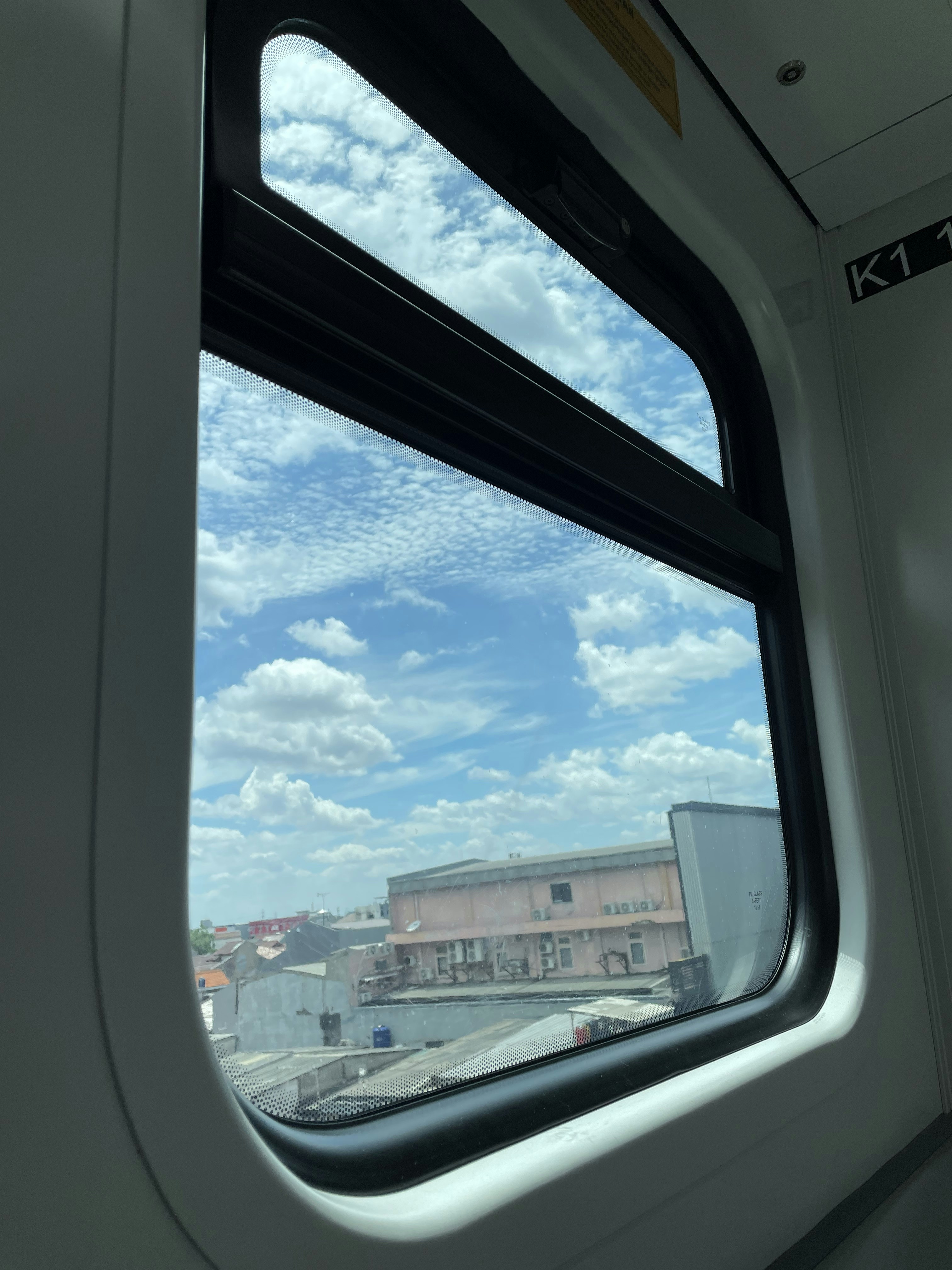a view of a building from a train window
