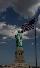 the statue of liberty is holding the american flag