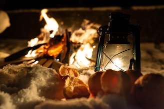 The heater emitting a gentle orange glow with a backdrop of winter snow outside a window.
