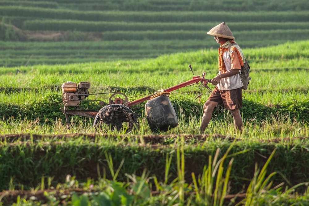 a man is plowing a field with a tractor