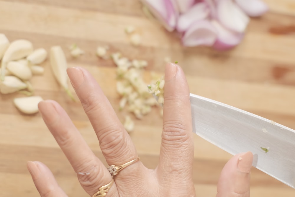 a woman is holding a knife in her hand