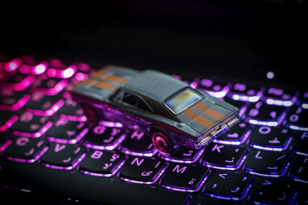 Close-up of a pink-themed electronic kit neatly arranged on a car dashboard.
