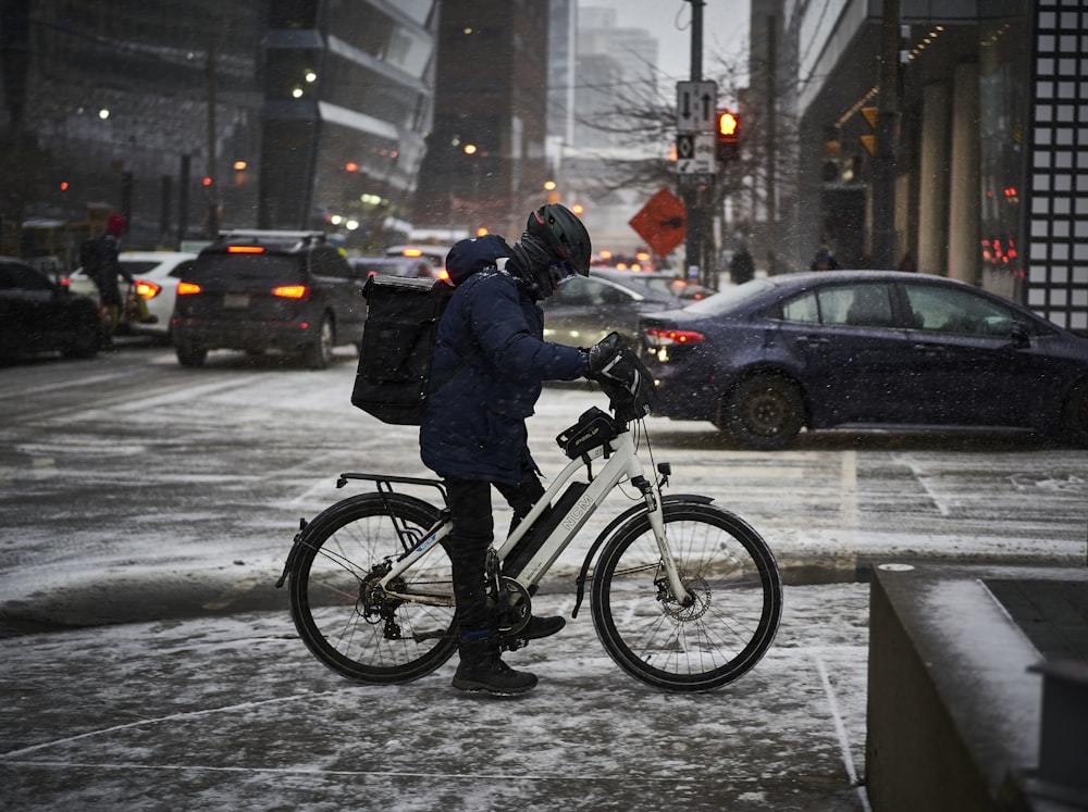 a person on a bike on a snowy street