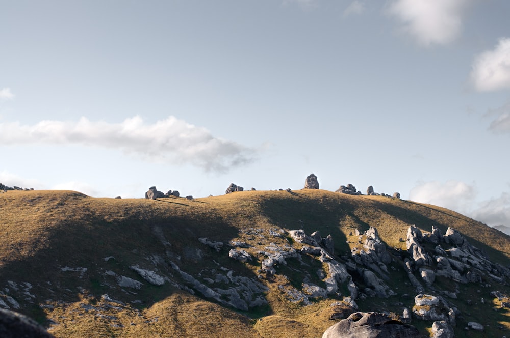 a group of rocks sitting on top of a hill