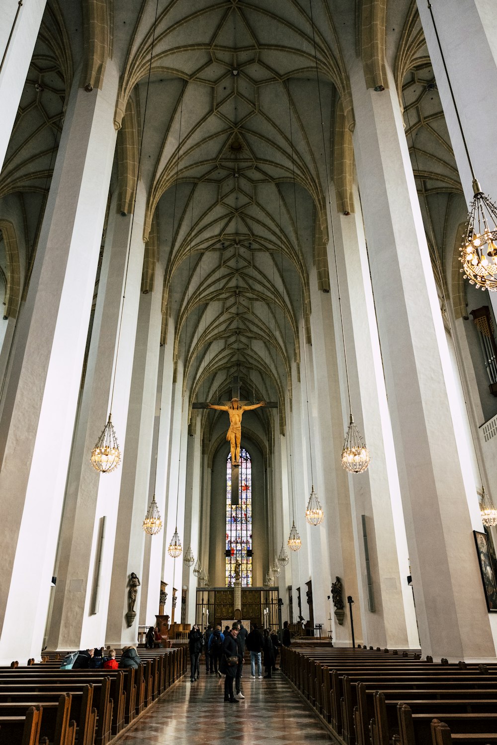 a large cathedral with a crucifix hanging from the ceiling
