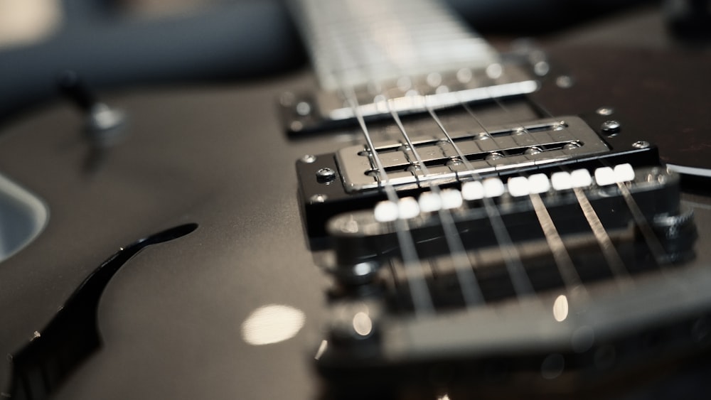 a close up of a black electric guitar