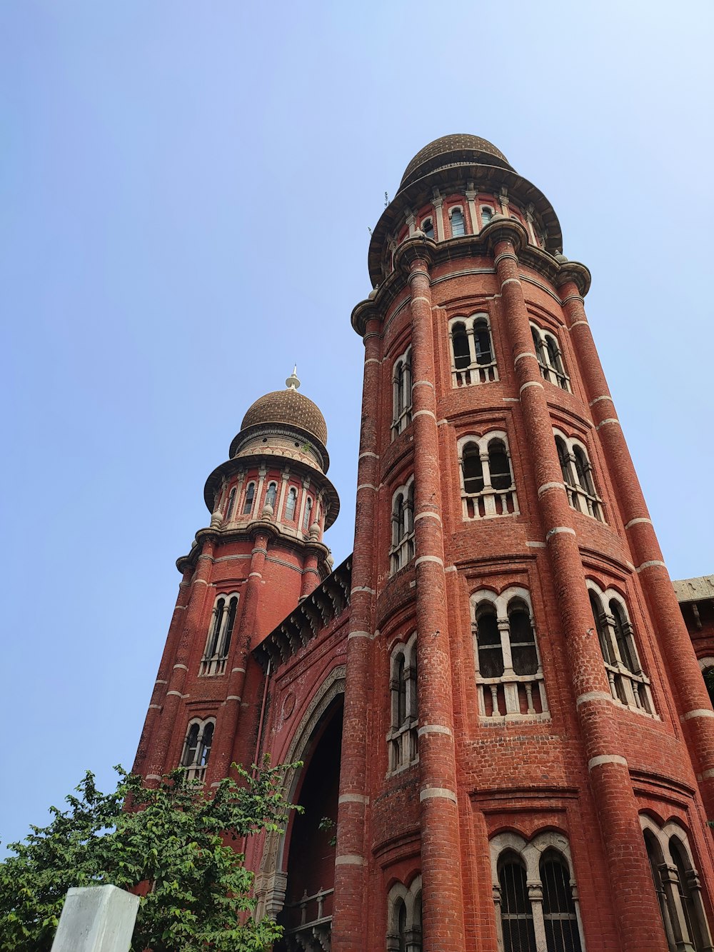 a large red brick building with two towers