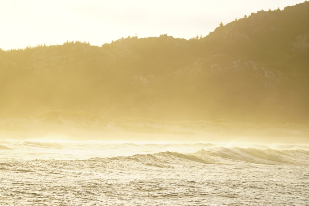 a man riding a surfboard on top of a wave in the ocean