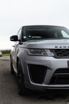 a silver range rover parked in a parking lot