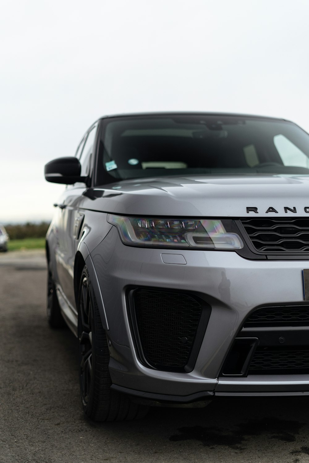 a silver range rover parked in a parking lot