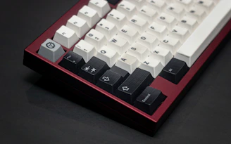 Mechanical keyboard with clean white keys and subtle red backlighting.