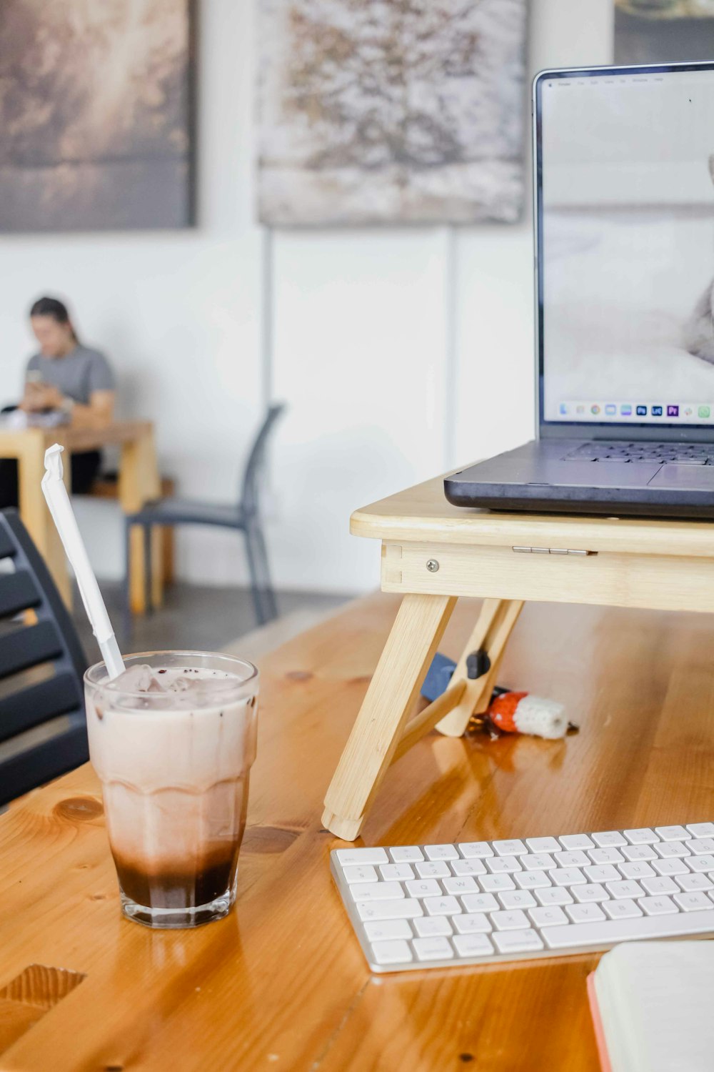 a glass of coffee and a laptop on a table