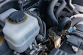 Close-up of a technician checking fluid levels during car maintenance.