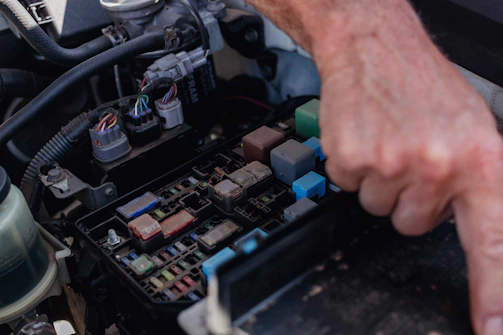 a close up of a person working on a car's engine
