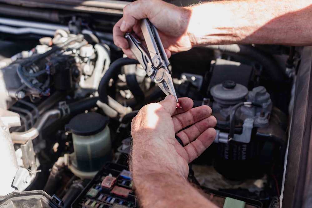 a man is working on a car engine