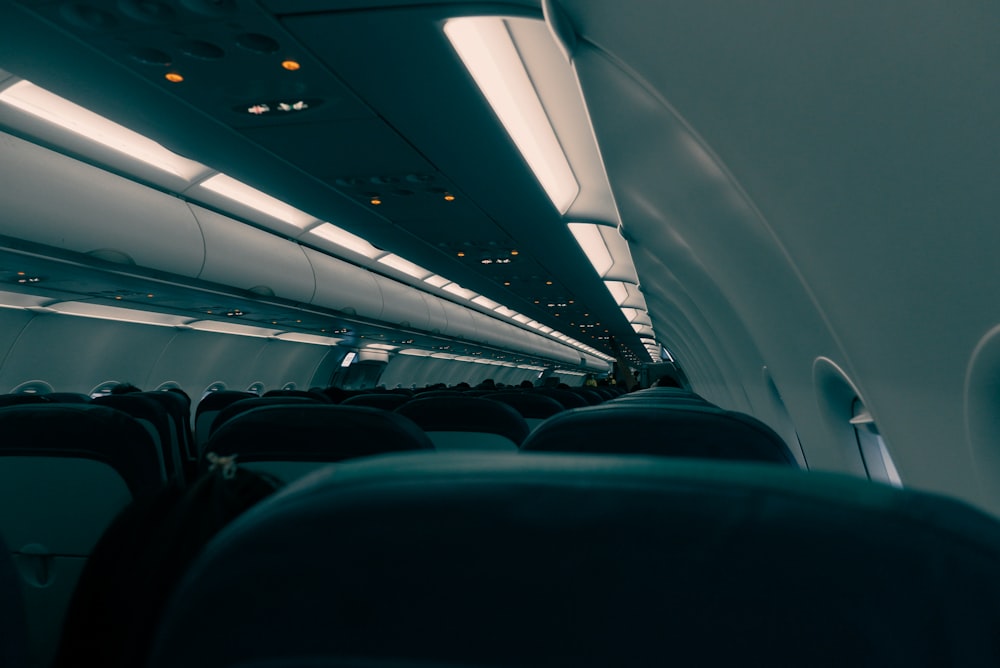 the inside of an airplane with the lights on