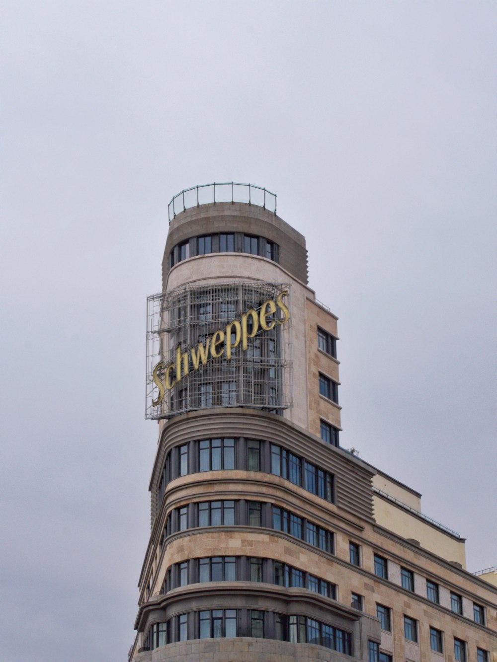 a tall building with a sign on top of it