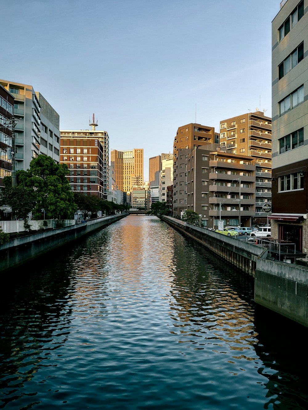 a river running through a city next to tall buildings