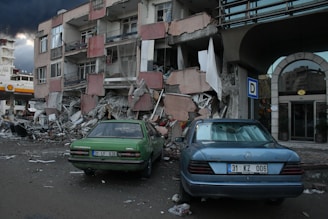 a couple of cars that are parked in front of a building