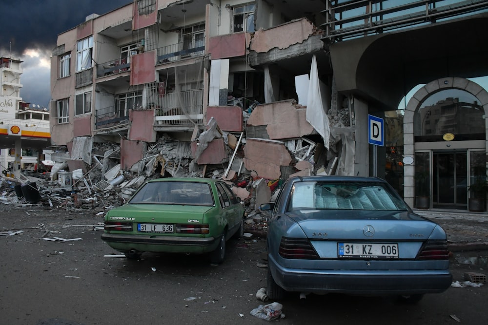 a couple of cars that are parked in front of a building