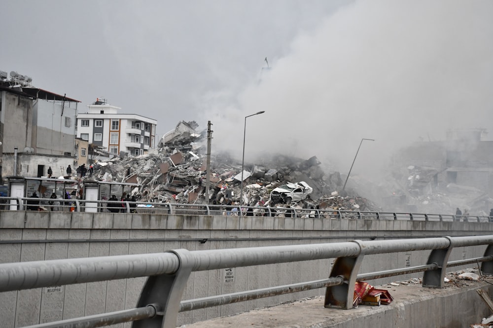 a large pile of rubble sitting on top of a bridge