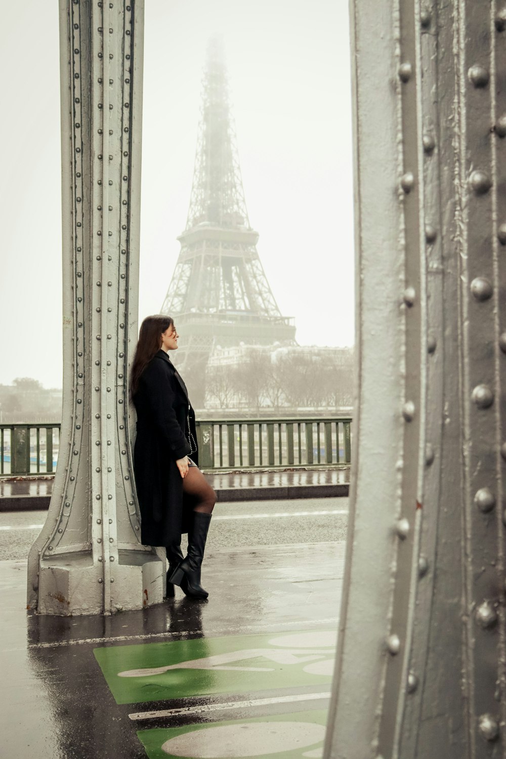 a woman standing in front of the eiffel tower