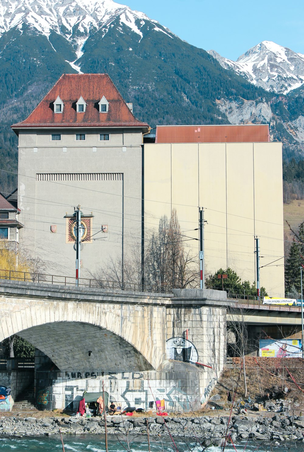 a bridge over a body of water with a building in the background