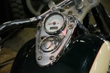 Close-up of the ionoki motorcycle's dashboard and controls illuminated in gold.