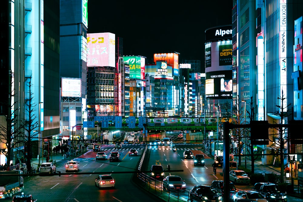 a city street filled with lots of traffic at night