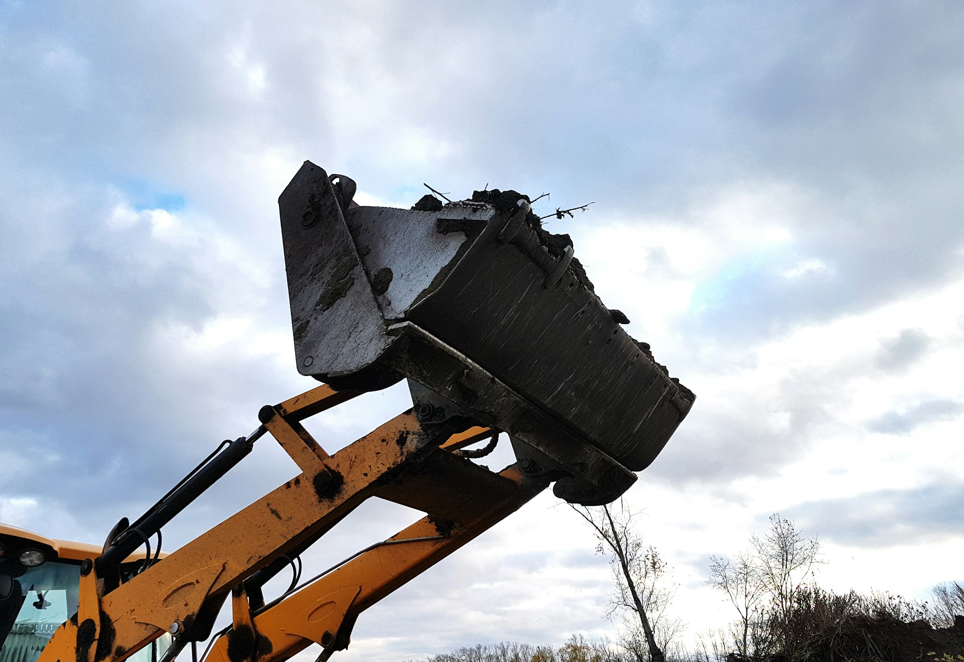 woman wearing yellow long-sleeved dress under white clouds and blue sky during daytime