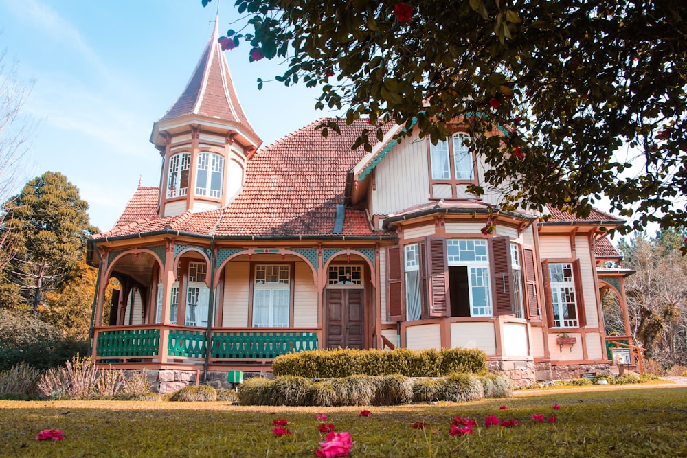 a pink and white house with a red roof