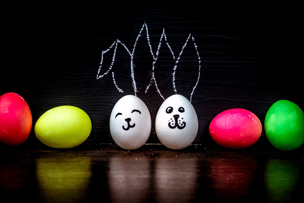 a group of eggs with faces drawn on them