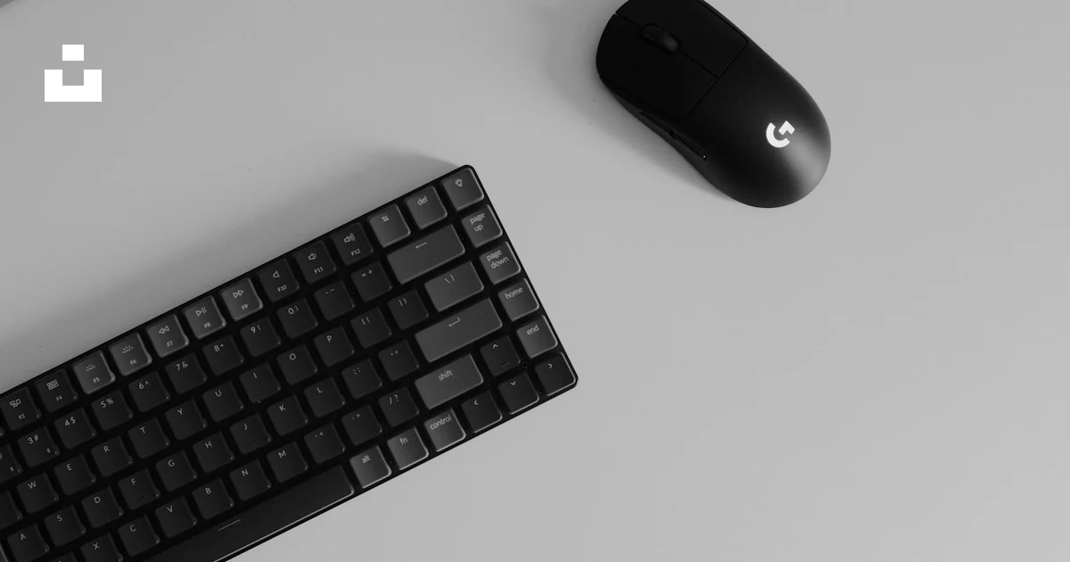 A computer keyboard and mouse on a desk photo – Free Mouse Image on ...