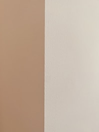 Close-up of a perfectly smooth drywall corner in a bright Cape Cod home.