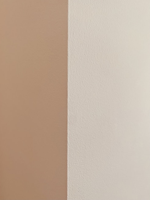 Close-up of a freshly repaired drywall corner with smooth, even texture and clean paint finish.