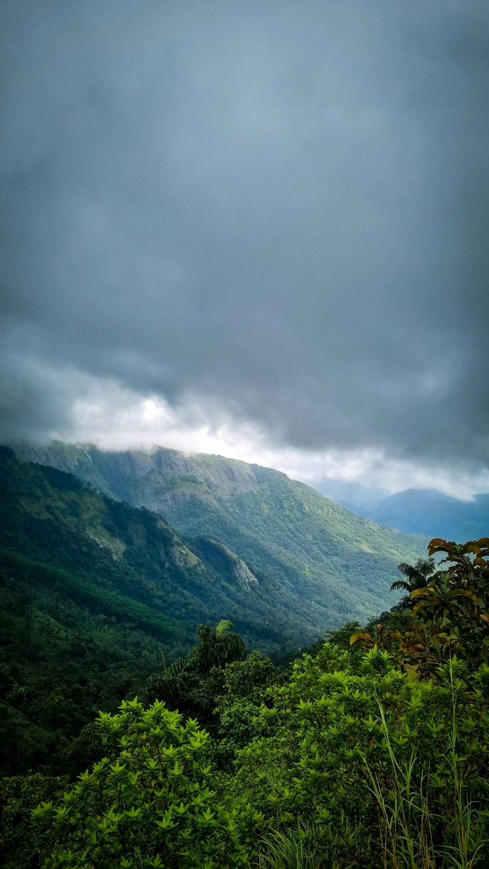 a view of a mountain range with clouds in the sky